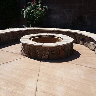 Firepit and banco seating with moss rock finish. 